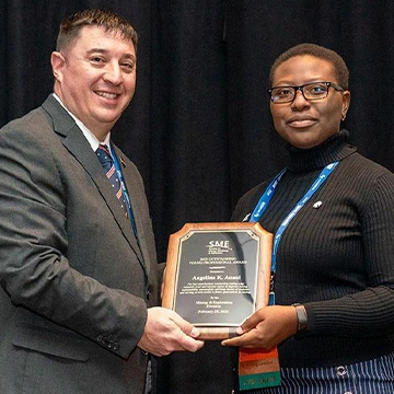 Angelina Anani, associate professor of UA MGE accepting an award