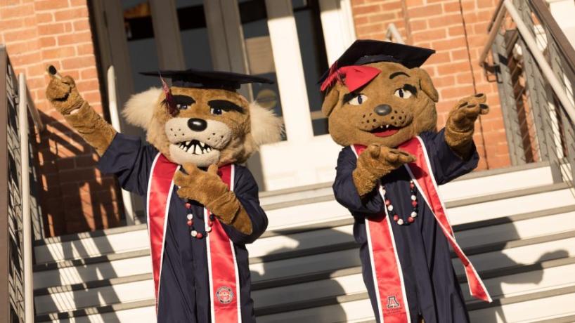 Wilbur and Wilma mascots in graduation regalia