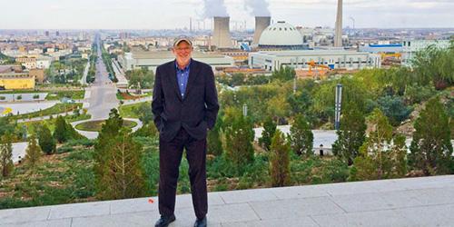 Steve Enders’ PhD in geosciences has taken him to the pinnacle of success in mining and the far reaches of the globe, including Jinchang, China, where he is pictured standing in front of a mine and processing plant.